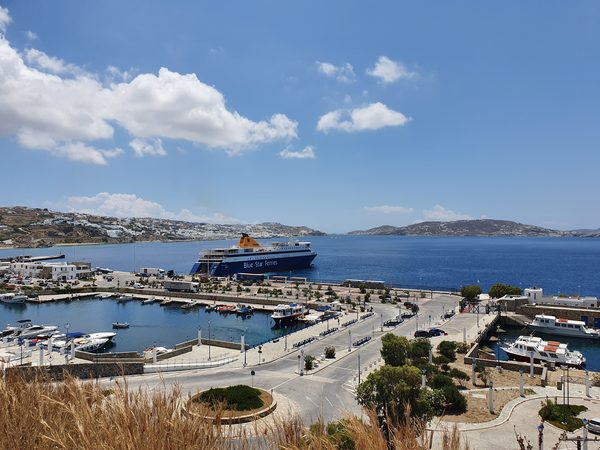 The new port at Tourlos, Mykonos, with a Blue Star ferry docked beside the harbour road and marina