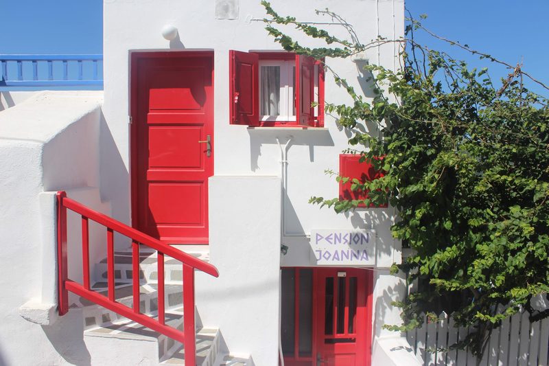 A traditional whitewashed house with blue accents in Mykonos.