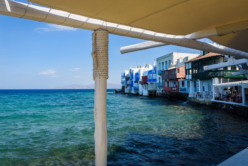 Colorful buildings line the waterfront in Little Venice, Mykonos, Greece.