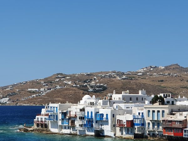 The colourful old houses of Little Venice in Mykonos town, their wooden balconies overhanging the sea