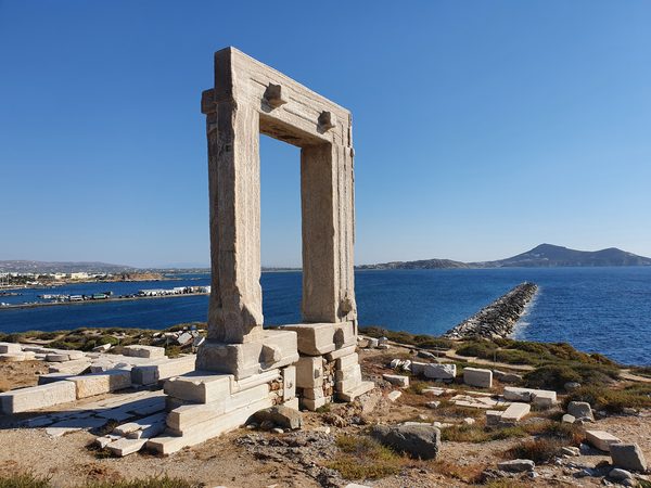 The Portara, a massive marble doorway standing alone on a rocky islet joined to Naxos Chora by a causeway